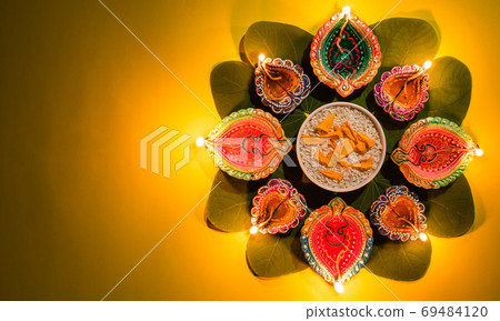 Happy Dussehra. Clay Diya lamps lit during Dussehra with yellow 69484120