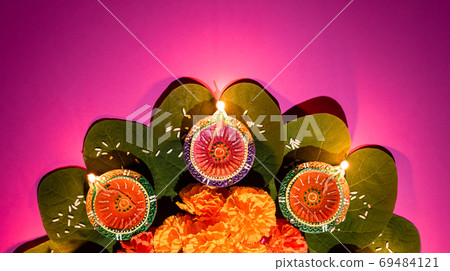 Happy Dussehra. Clay Diya lamps lit during Dussehra with yellow 69484121
