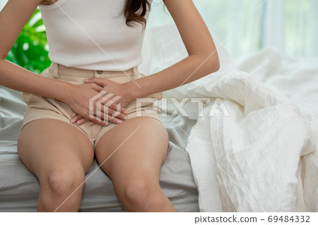 woman have bladder pain and stomach ache sitting on bed in bedroom after wake up feeling so sick and painful,Healthcare concept woman have bladder pain and stomach ache sitting on bed in bedroom after wake up feeling so sick and painful,Healthcare concept 69484332