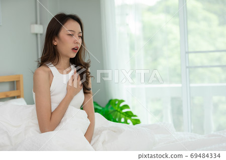 Woman have a heart attack in chest pain after wake up in the morning,Healthcare Concept Woman have a heart attack in chest pain after wake up in the morning,Healthcare Concept 69484334