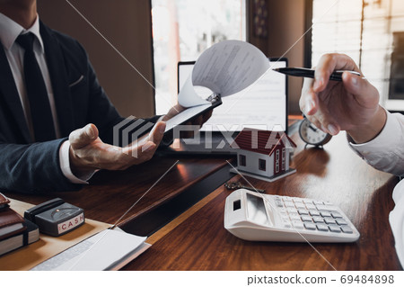 Business people home sales broker is using a pen pointing to the Business people home sales broker is using a pen pointing to the 69484898