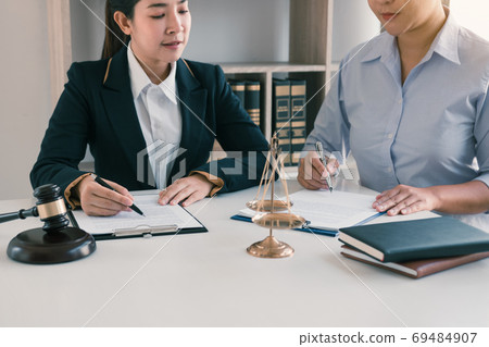 Woman judge is currently advising clients on their requests for Woman judge is currently advising clients on their requests for 69484907