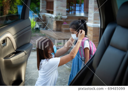Mother help her daughter wear protection mask to protect the coronavirus Covid-19 outbreak situation 69485099
