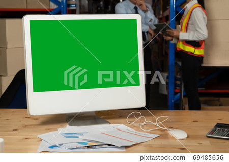 Computer with green screen display in warehouse storage room 69485656