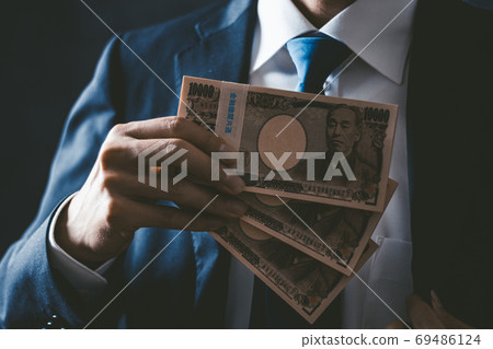 Businessman with a bundle 69486124