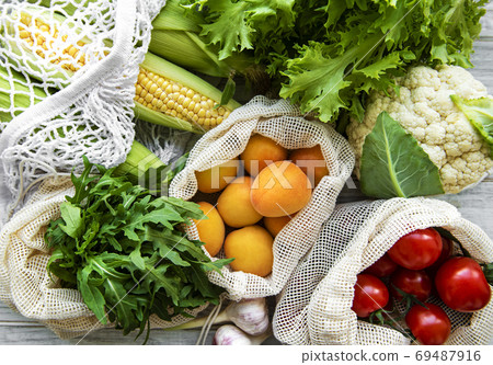 Fresh fruits and vegetables in eco cotton bag Fresh fruits and vegetables in eco cotton bag 69487916