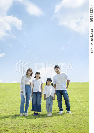 Family standing outdoors snuggling up Family parents and children 69488092