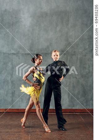 Ballroom dance samba. Young couple in yellow and black clothes dancing. 69488286