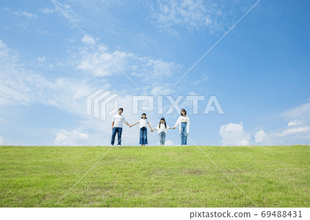 Family standing in a row outdoors Family parent and child 69488431