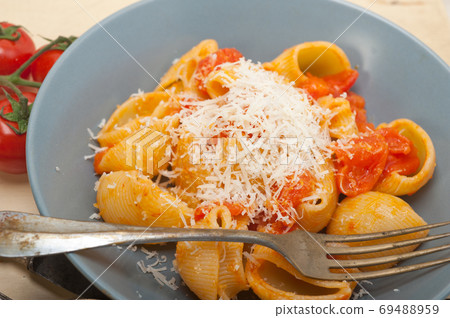 Italian snail lumaconi pasta with tomatoes Italian snail lumaconi pasta with tomatoes 69488959