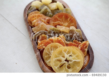 Various kinds of dried fruits arranged on a wooden plate Various kinds of dried fruits arranged on a wooden plate 69489130