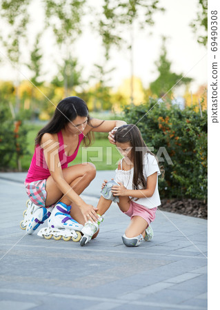 little child girl falled down while rolling with her mother 69490308