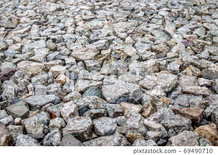 Background of gray stones at a road repair construction site as a drainage layer for paving asphalt 69490710