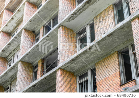 Facade of an old abandoned apartment building 69490730