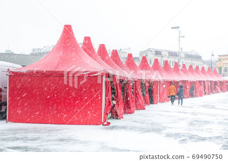 Christmas tents at the downtown fairground during a blizzard Christmas tents at the downtown fairground during a blizzard 69490750