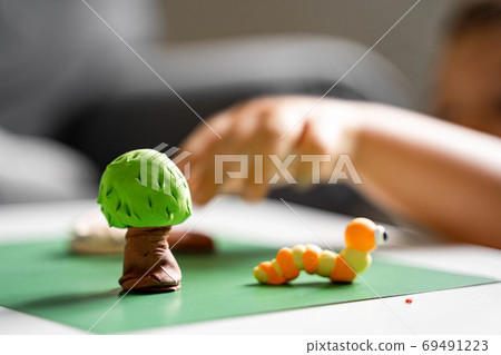 Caucasian toddler girl playing modeling play dough at home with mother. Homeschooling concept 69491223