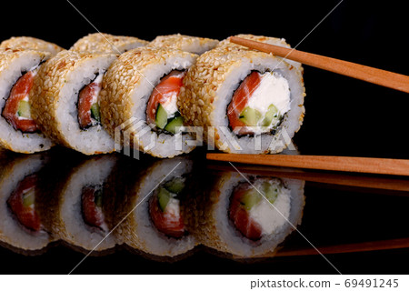 Fresh delicious beautiful sushi rolls on a dark background 69491245