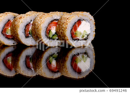 Fresh delicious beautiful sushi rolls on a dark background 69491246