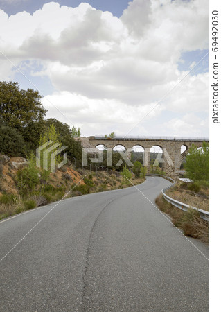 Road passing under a railway bridge 69492030