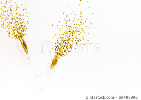 Champagne glasses with golden confetti tinsel on white background. Flat lay, top view celebrate party concept. 69495990