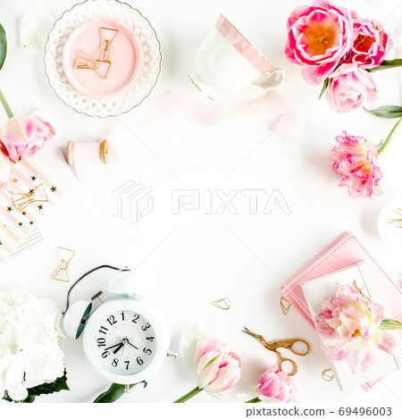 Fashion blog pink style desk with accessories, tulip flowers, scissors, coffee cup on white background. Flat lay. Top view. 69496003