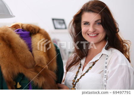 Smiling sewer in workshop 69497791