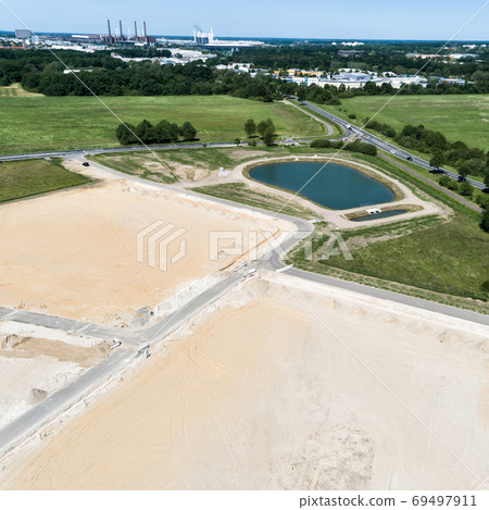 Obliquely taken aerial view of a construction site  69497911