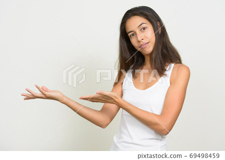 Portrait of beautiful multi ethnic woman showing something 69498459