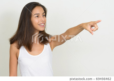Portrait of happy beautiful multi ethnic woman pointing finger Portrait of happy beautiful multi ethnic woman pointing finger 69498462
