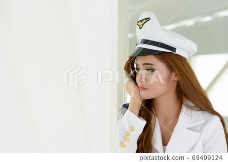 Face of stressed young Asian navy woman thinking indoors Face of stressed young Asian navy woman thinking indoors 69499124
