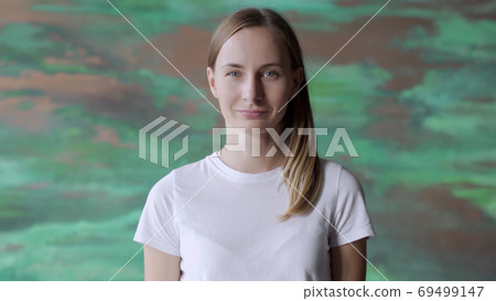 Smiling beautiful businesswoman standing in creative office Smiling beautiful businesswoman standing in creative office 69499147