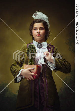 Modern trendy look, portrait of renaissance period beautiful woman. Retro style, comparison of eras concept. Modern trendy look, portrait of renaissance period beautiful woman. Retro style, comparison of eras concept. 69499544