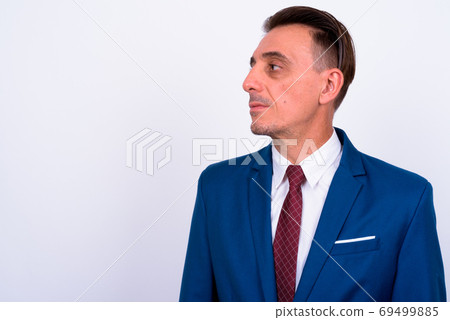 Mature handsome Italian businessman against white background Mature handsome Italian businessman against white background 69499885
