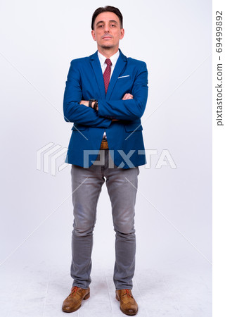 Mature handsome Italian businessman against white background Mature handsome Italian businessman against white background 69499892