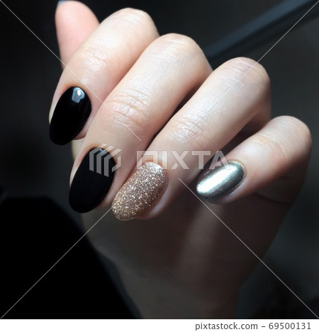 Black female manicure on the nails of a woman Black female manicure on the nails of a woman 69500131