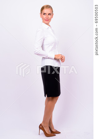 Full body shot of beautiful blonde businesswoman thinking 69500503