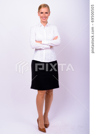 Full body shot of happy beautiful blonde businesswoman smiling 69500505