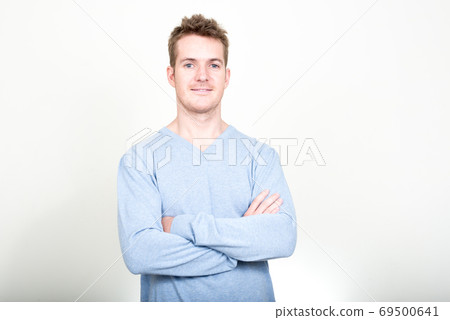 Portrait of happy handsome man smiling with arms crossed 69500641