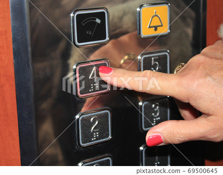 Female person pushing elevator button. Female person pushing elevator button. 69500645
