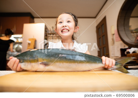 Girl with big fish 69500806