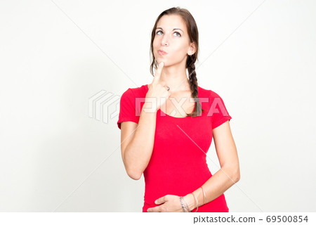 Portrait of young beautiful woman with brown hair thinking 69500854