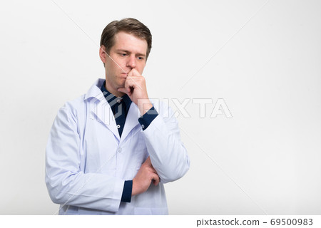 Portrait of stressed young man doctor thinking 69500983