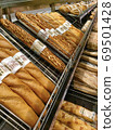 French bread with a nice smell that is browned and burnt on the display shelves in the supermarket 69501428