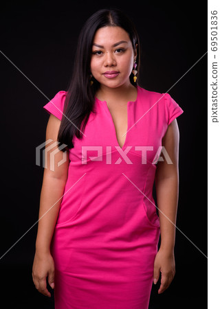Portrait of beautiful overweight Asian woman in pink dress 69501836