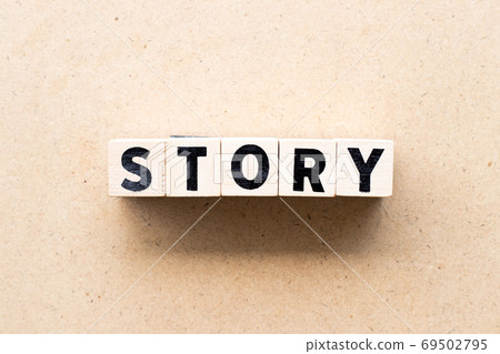Letter block in word story on wood background 69502795