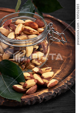 Open jar filled with Brazil nuts close up Open jar filled with Brazil nuts close up 69502803