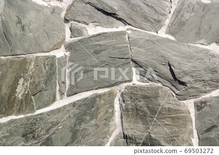 fragment of a wall of gray natural stone 69503272