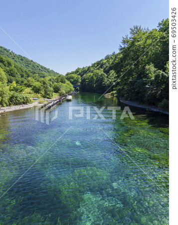 Emerald green Chitose River and small boat 69503426