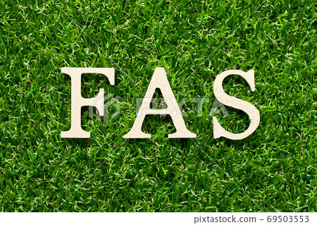Wood alphabet letter in word FAS (abbreviation of Free alongside) on green grass background Wood alphabet letter in word FAS (abbreviation of Free alongside) on green grass background 69503553
