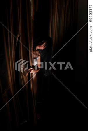 full length ghost woman in haunted hotel with dark filter, halloween concept 69503575